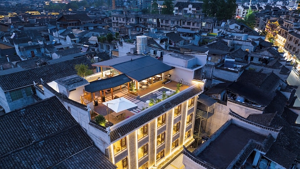 A traditional building with a rooftop terrace, multiple floors, and a courtyard. - Fenghuang Story Hotel (Xiangxi)