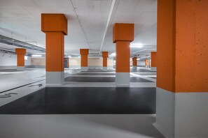A parking garage with multiple levels and orange pillars.