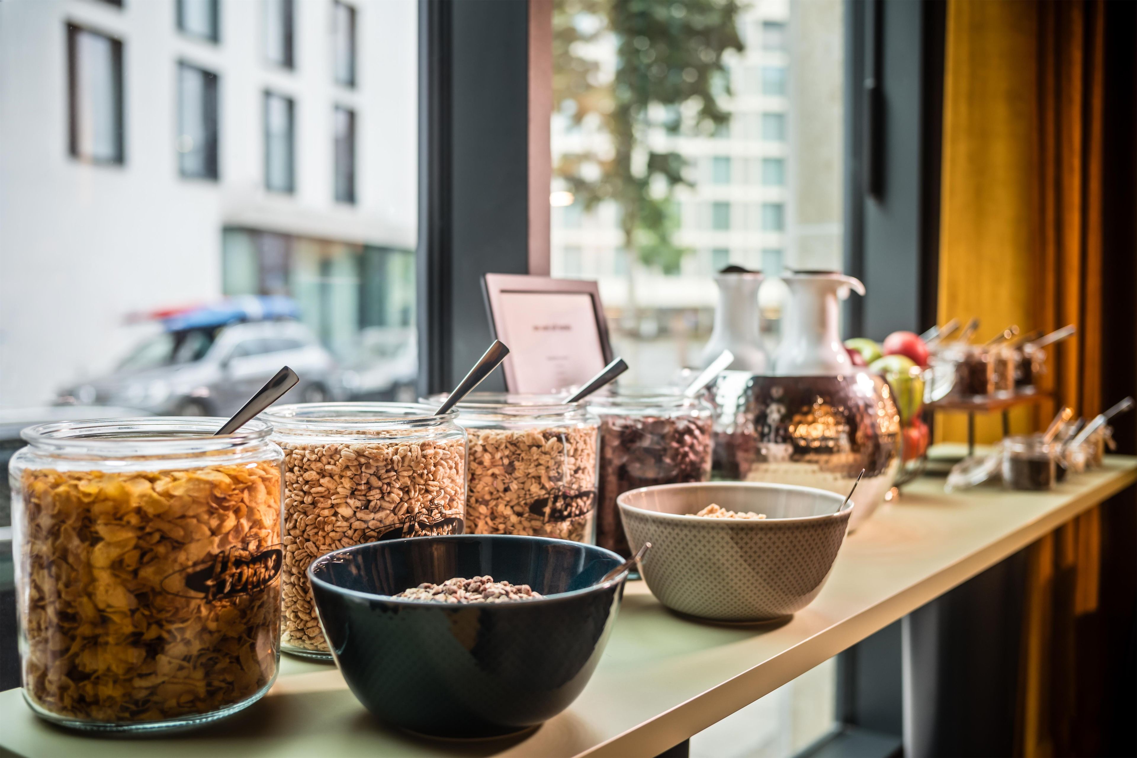 A buffet table with various food items and containers.