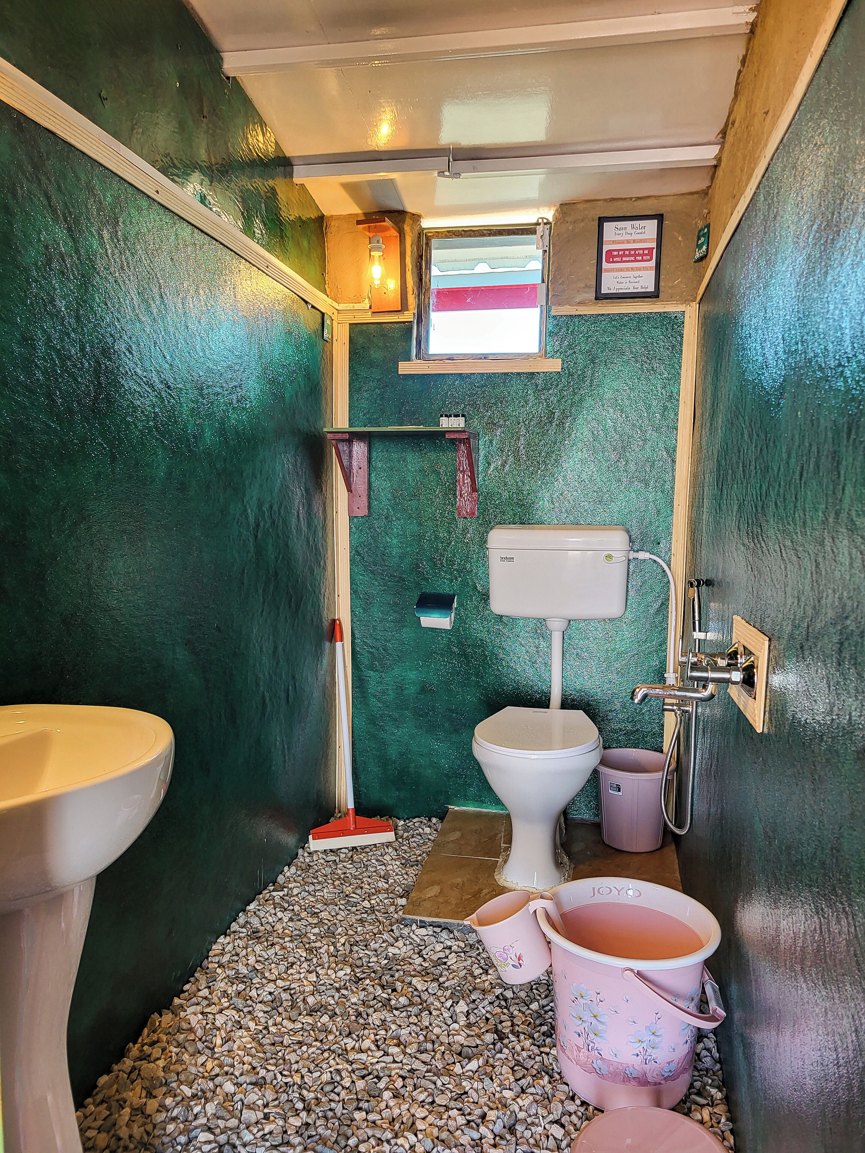 A compact bathroom with a toilet, sink, and shower.