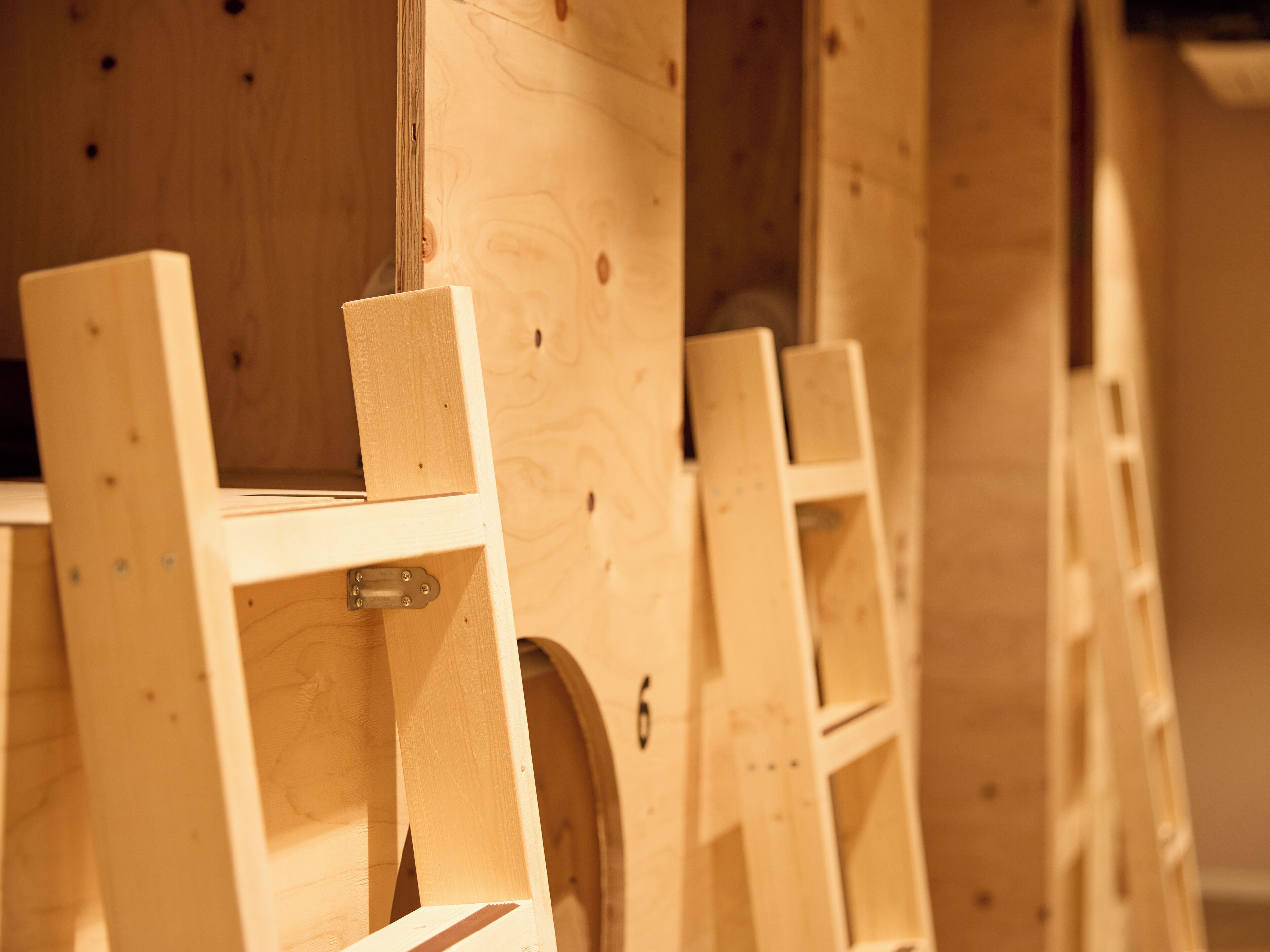 Wooden furniture with a simple design, featuring a shelf and a circular cutout.