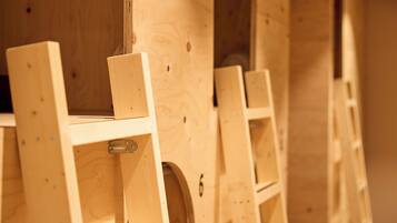 Wooden furniture with a simple design, featuring a shelf and a circular cutout.