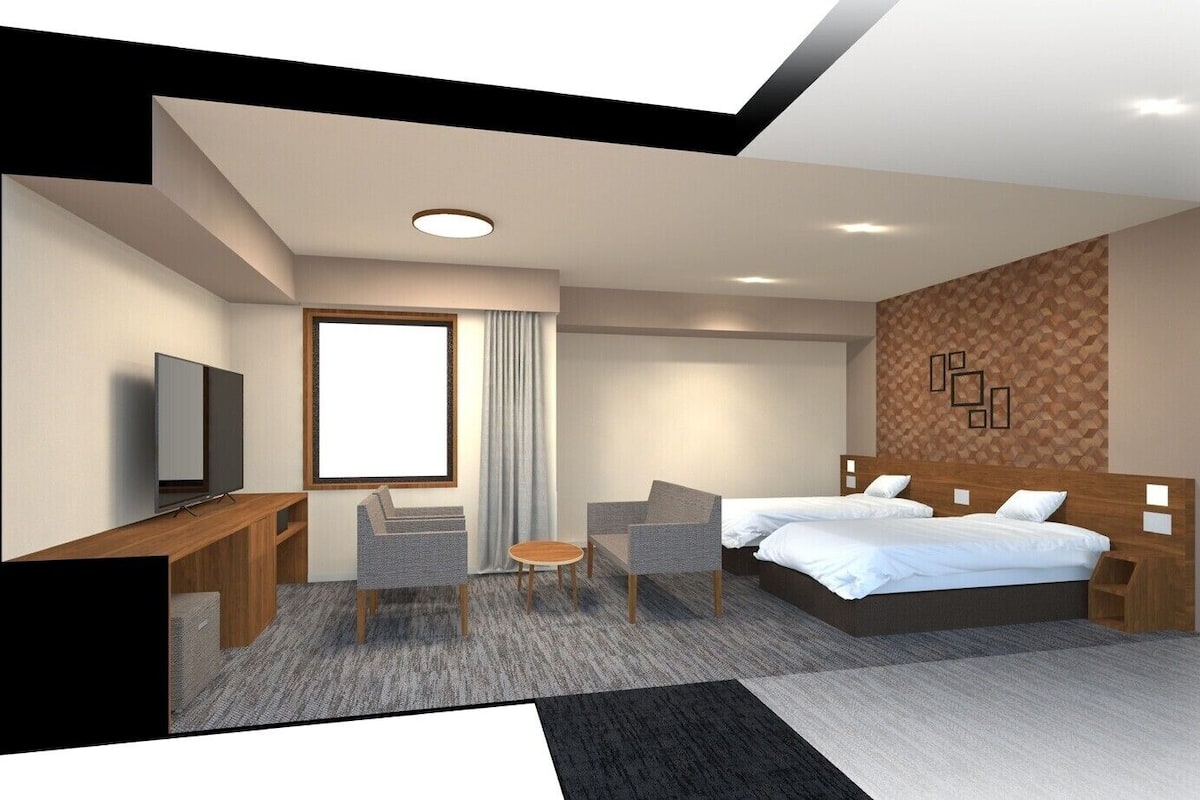 Una habitación de hotel moderna con cama, escritorio, televisor y zona de estar.