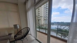 A balcony with a view of a residential area and a body of water. - Borneo Holiday Suite @ Riverine Diamond Kuching (Kuching)