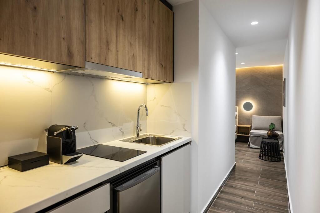 A modern kitchen with a built-in dishwasher, a sink, and wooden cabinets.