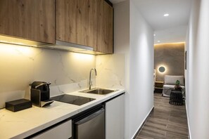 A modern kitchen with a built-in dishwasher, a sink, and wooden cabinets.