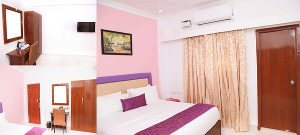 A hotel room with a bed, a desk with a chair, a wardrobe, a television, and an air conditioning unit.