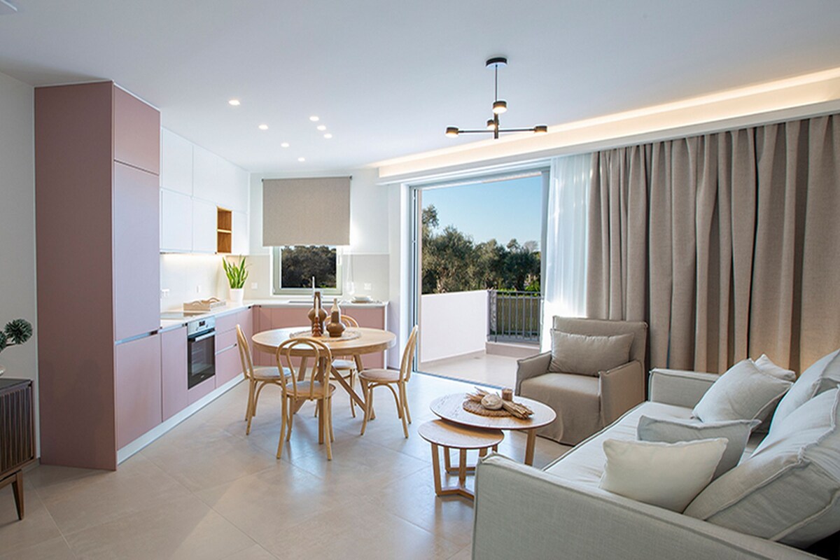 A modern apartment with a kitchen, dining area, and living room.