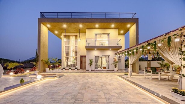 A modern building with a spacious courtyard, large windows, and outdoor seating areas. - Heaven in Hills By ELIVAAS with pvt pool (Māvli)