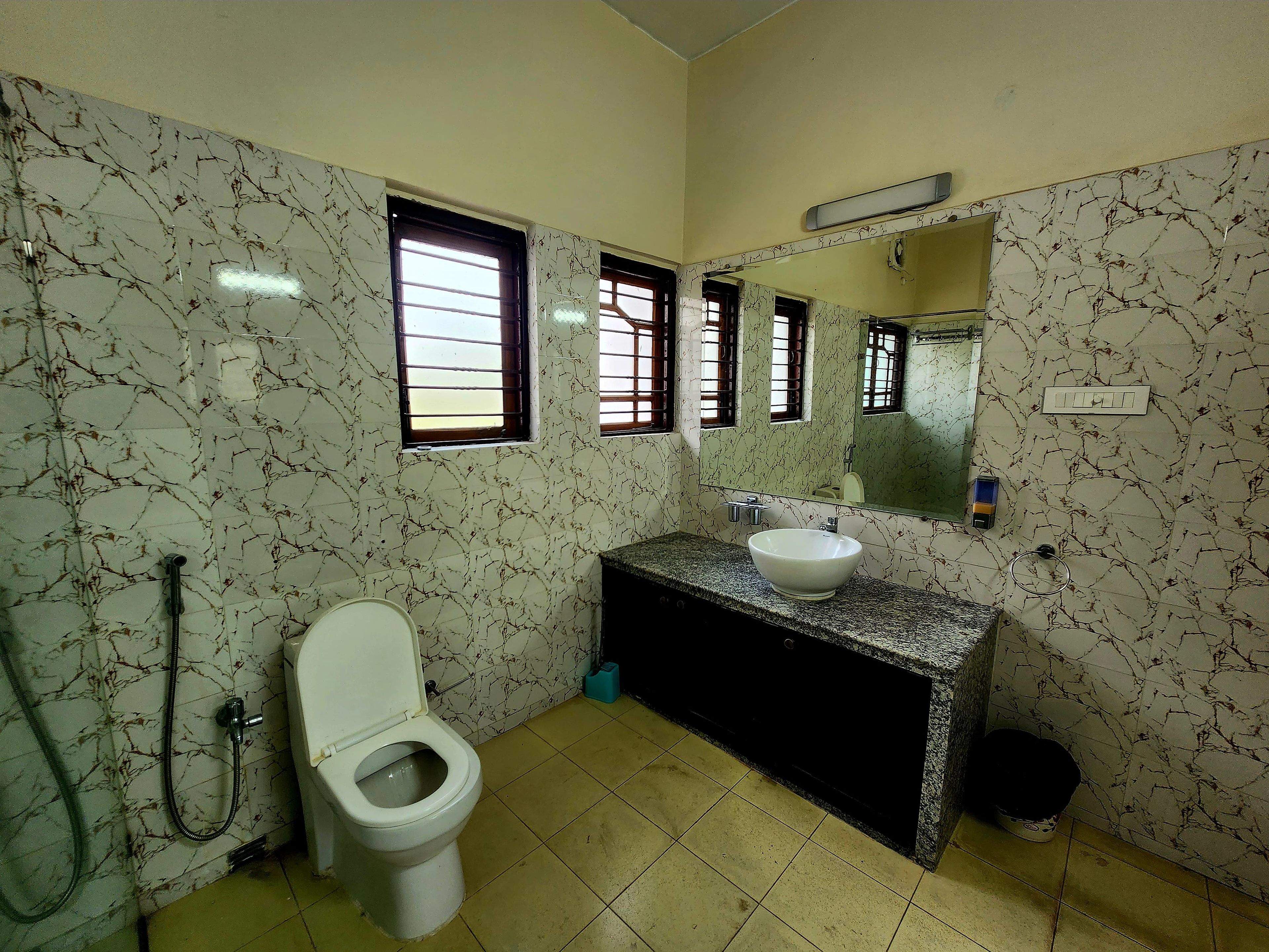 A bathroom with a toilet, sink, and shower.