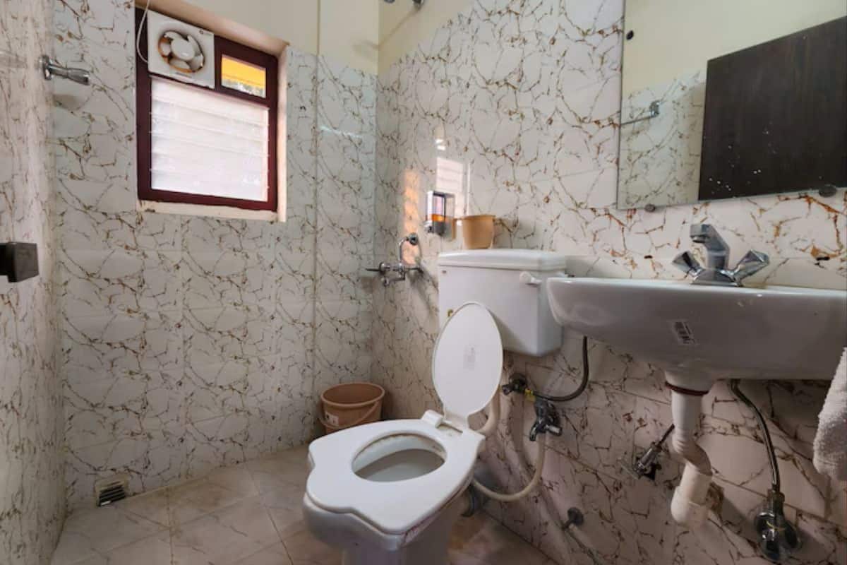 A bathroom with a toilet, sink, and shower.