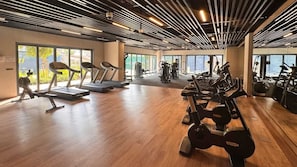A spacious gym with treadmills, stationary bikes, and weight machines. - Premium 2BR at City Walk, High-End Furnished (Dubai)