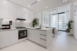 Fridge, microwave, oven, stovetop - Luxury 1BR Haven - Prime Location - Newly Built (Dubai)