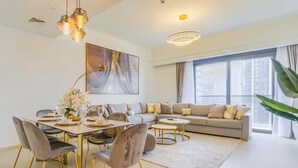 Een moderne woonkamer met een eethoek, een groot raam en uitzicht op de stad.