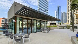 Outdoor dining - Stylish 1BR - Canal & Burj View - Business Bay (Dubai)