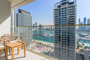 A balcony with a view of a marina and high-rise buildings. - Atlantis & Marina View, Private Beach, Furnished (Dubai)