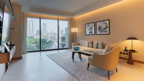 A modern living room with a sofa, coffee table, and a large window offering a city view. - Full Burj Khalifa View, Luxury 3BR Unit, Downtown (Dubai)