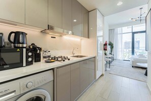 Fridge, microwave, oven, stovetop - Sleek & Cozy Studio - Central MBR City, Dubai (Dubai)