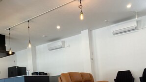 A modern living room with a dog, a sofa, and a kitchen area. - Irorian (Kamakura)