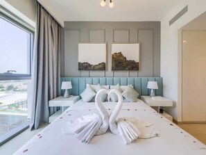 A hotel room with a large bed, two bedside tables, a headboard with a landscape painting, and a view of the outdoors. - City Skyline View, 1BR Luxury, Access - Dubai Mall (Dubai)