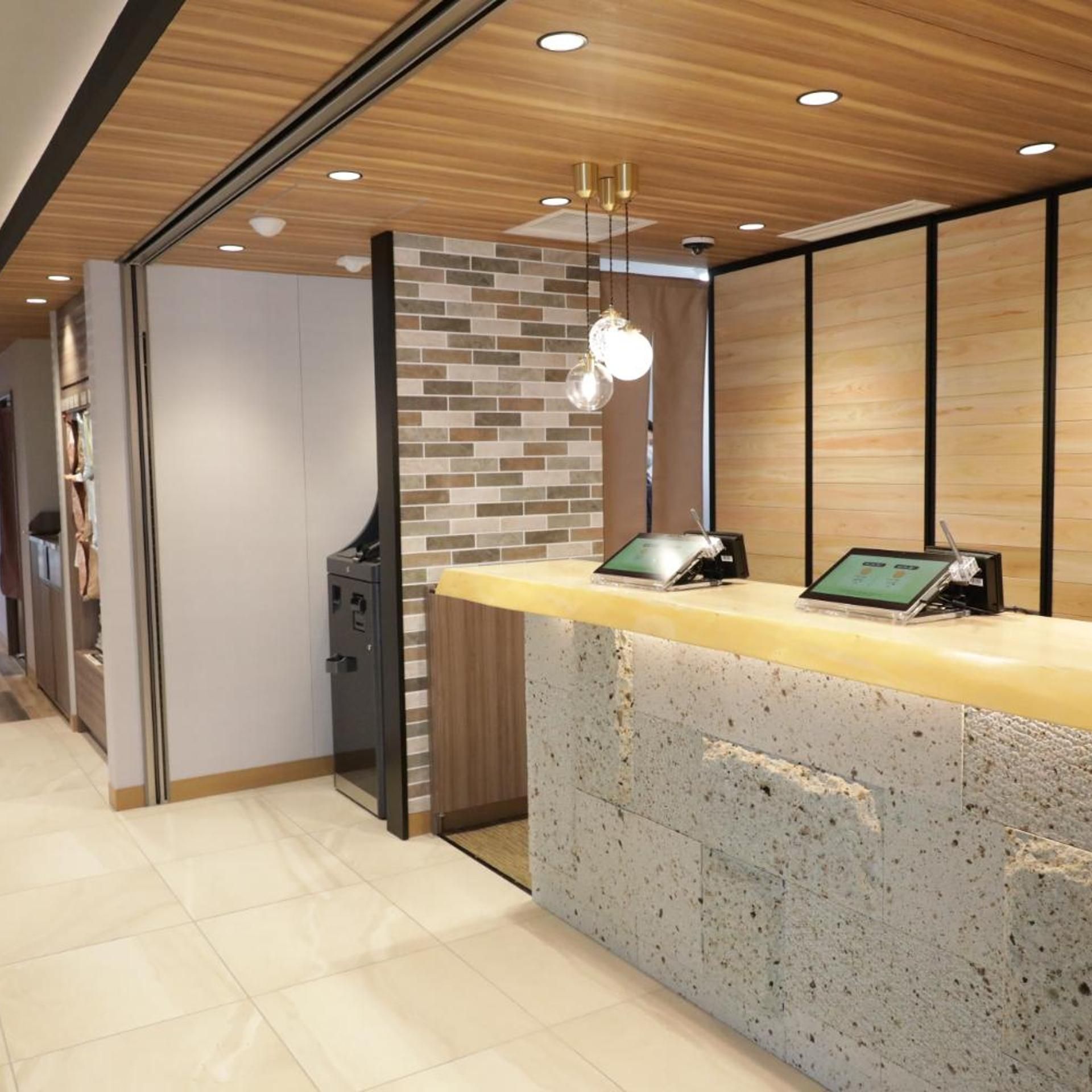 A reception desk with a digital screen, a cash register, and a safe.
