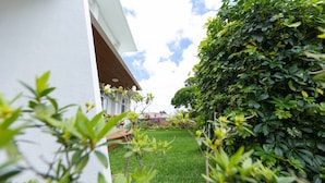 A modern building with a white exterior and a covered outdoor area.