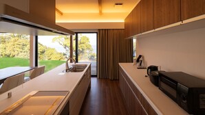 A modern kitchen with a large window, a microwave, and a sink. - Workation Resort THE Forest (Nagatoro)