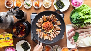 A table with various Korean dishes, including kimchi, seafood, and meat, arranged for a meal. - Workation Resort THE Forest (Nagatoro)