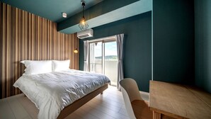 Une chambre à coucher avec un lit, un bureau et une chaise. Il y a une fenêtre avec des rideaux et une vue sur l’extérieur.