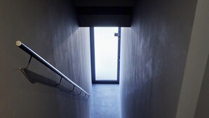 A staircase with a metal handrail and a wooden handrail at the top. - Toutou Onzaki Nikai no Yado (Kurashiki)