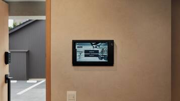 A digital display mounted on a wall with options for 'CHECK-IN' and 'CHECK-OUT'.