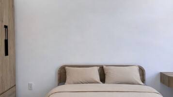 A bedroom with a bed, a wardrobe, and a nightstand.