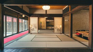 A traditional Japanese room with tatami flooring, sliding doors, and a wooden ceiling. - The Timeless Hotel Loof Yunoie (Yachiyo)