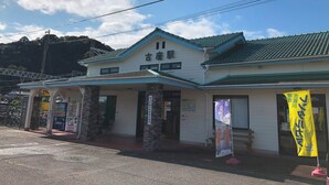 A building with a traditional architectural style, featuring a tiled roof and a signboard with Japanese characters. - Granny's House (Kozagawa)