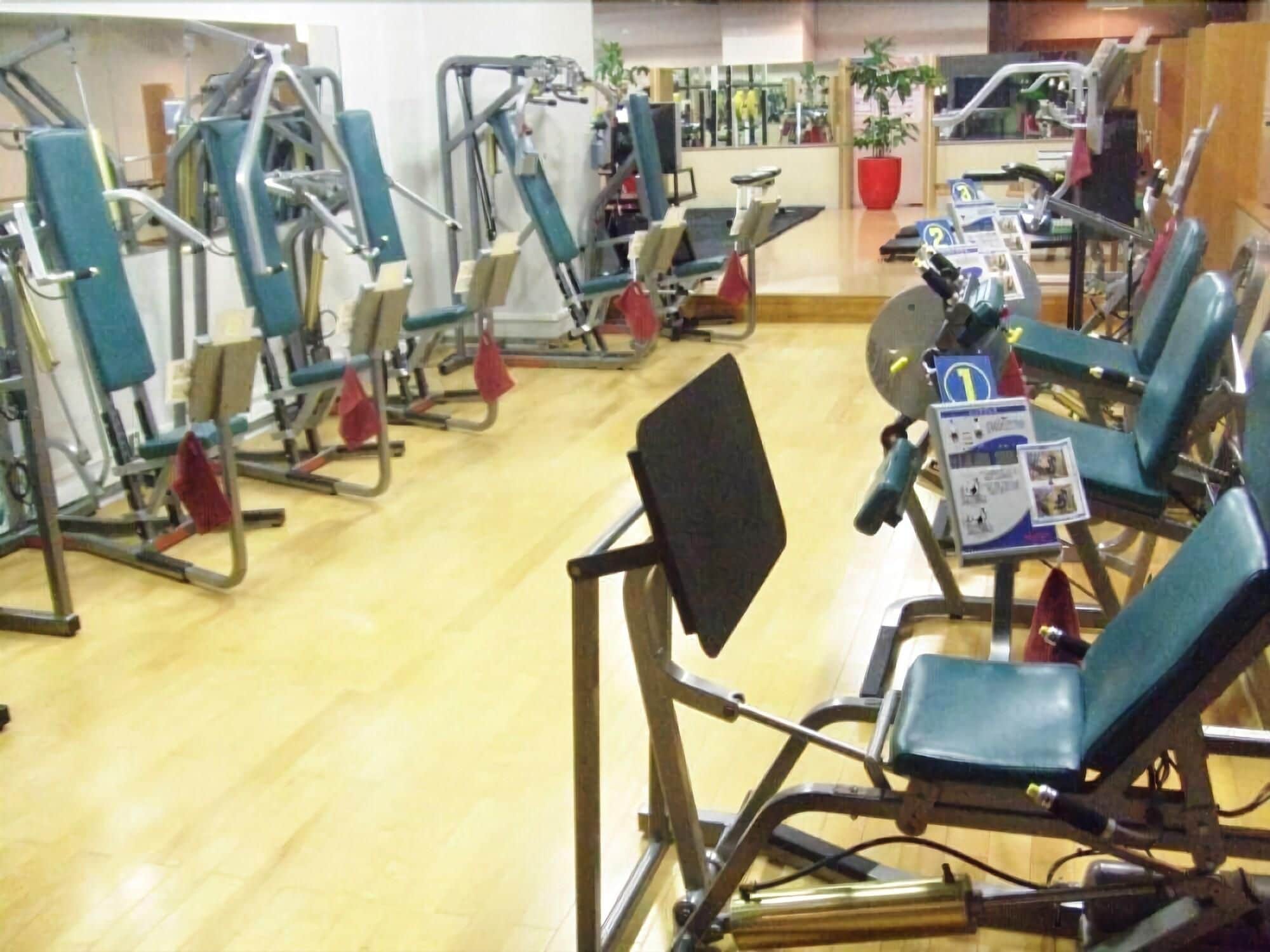 A gym with various exercise machines and equipment.