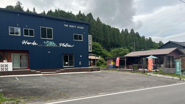 A blue building labeled "The Guest House" with a mountain graphic and "Handa Plateau" written on it.