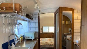A compact kitchen with a sink, a toaster, and a window. - Isola Base Awaji (Awaji)
