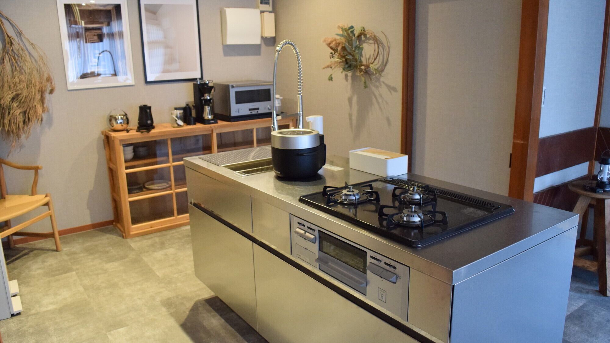 A compact kitchen with a central island, built-in oven, and a gas stove.