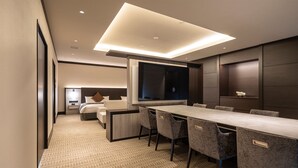 A modern hotel room with a large bed, a desk with chairs, a large window, and a flat-screen TV. - Hotel R9 Premium Ichikawa Ekimae (Ichikawa)