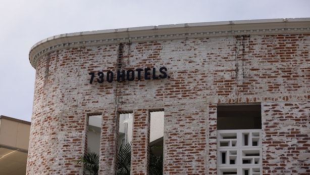A building with a sign reading "730HOTELS." It features a brick facade with a circular design and multiple windows. - 730 Hotels (Ishigaki)