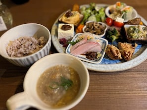 A variety of dishes on a table, including rice, meat, and vegetables.