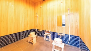 A wooden spa room with a wooden bench, a small table with bottles, and a large basin. - Teihaku Chichibu Nagatoro Folk House Rental (Nagatoro)