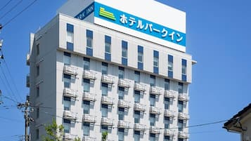 A multi-story hotel building with a prominent sign indicating it is a hotel.