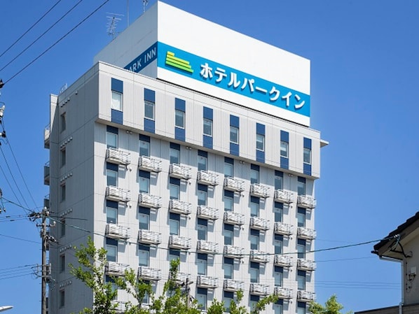 A multi-story hotel building with a prominent sign indicating it is a hotel. - Hotel Park Inn Takaoka (Takaoka)
