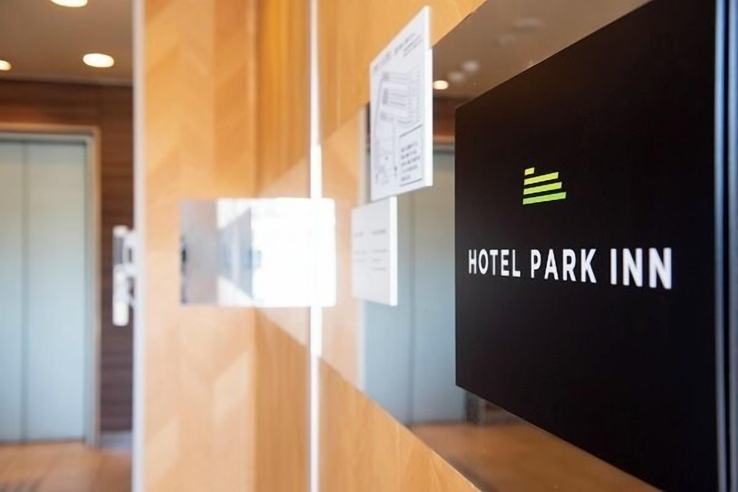 A reception area with a sign reading "HOTEL PARK INN".