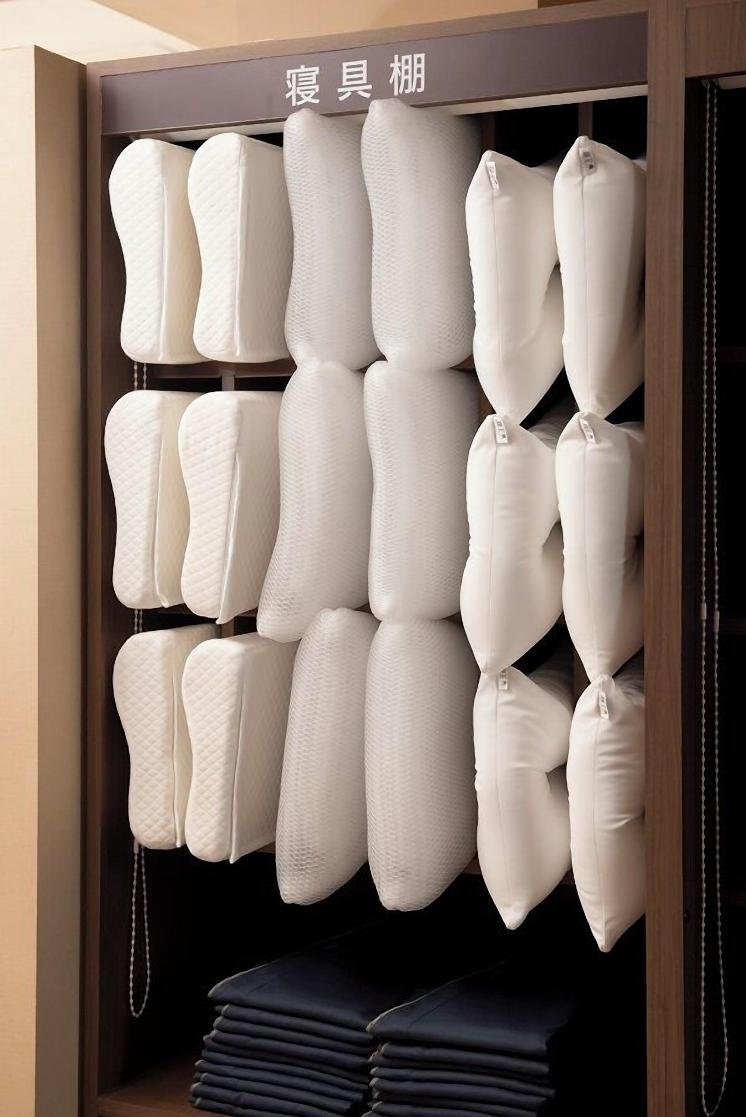 A storage unit with multiple padded cushions and folded blankets.