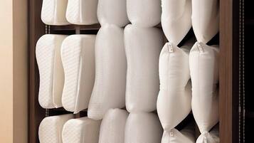 A storage unit with multiple padded cushions and folded blankets.