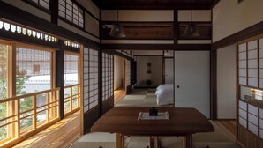 Een traditionele Japanse kamer met tatami vloerbedekking, een lage houten tafel en schuifdeuren van shoji.