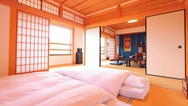 A traditional Japanese room with tatami flooring, a futon bed, sliding doors, and a shoji screen. - Nison-in Shukubo Entoki (Nagato)