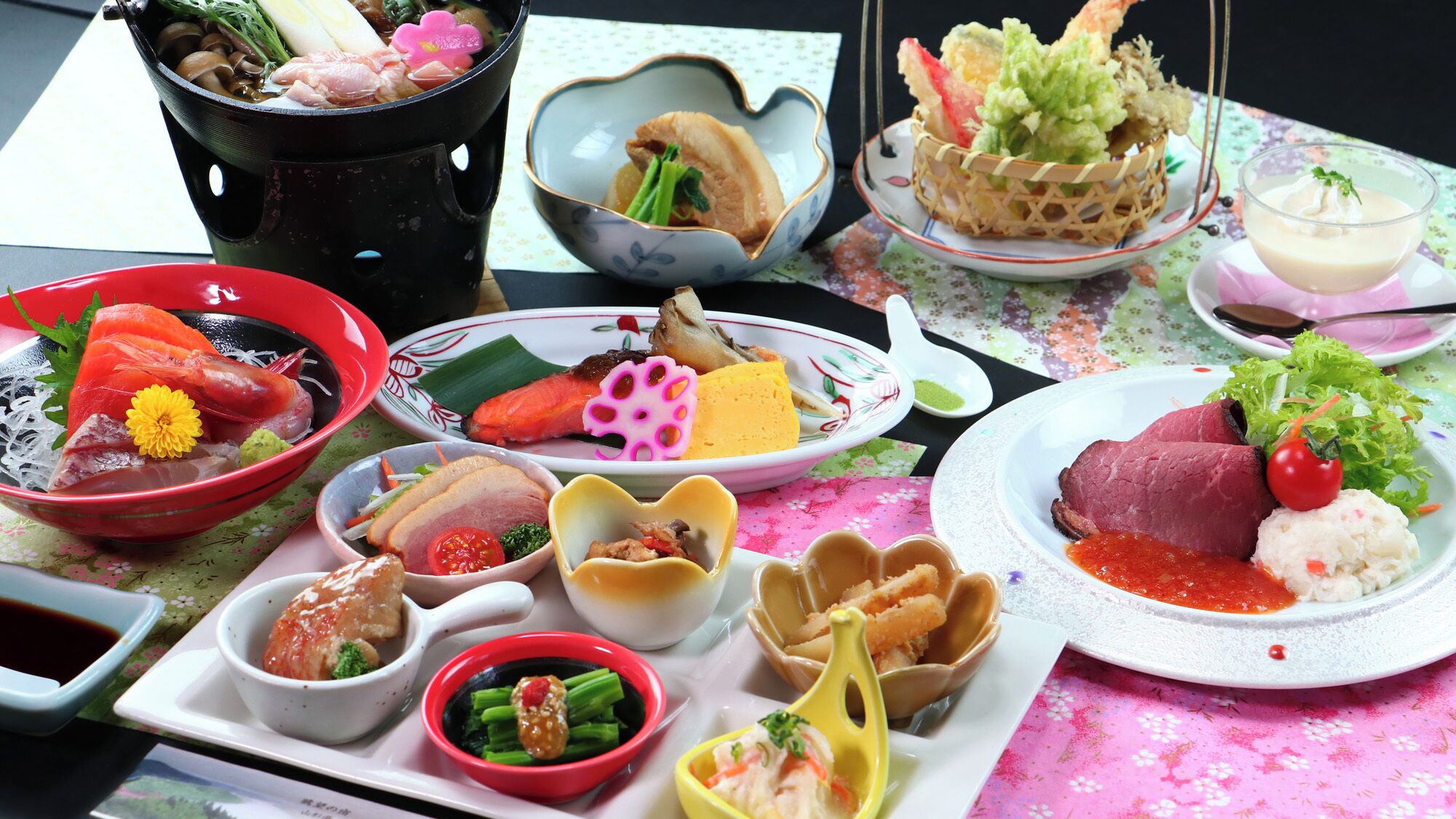 A variety of Japanese dishes including sushi, sashimi, and tempura on a table with a floral tablecloth.
